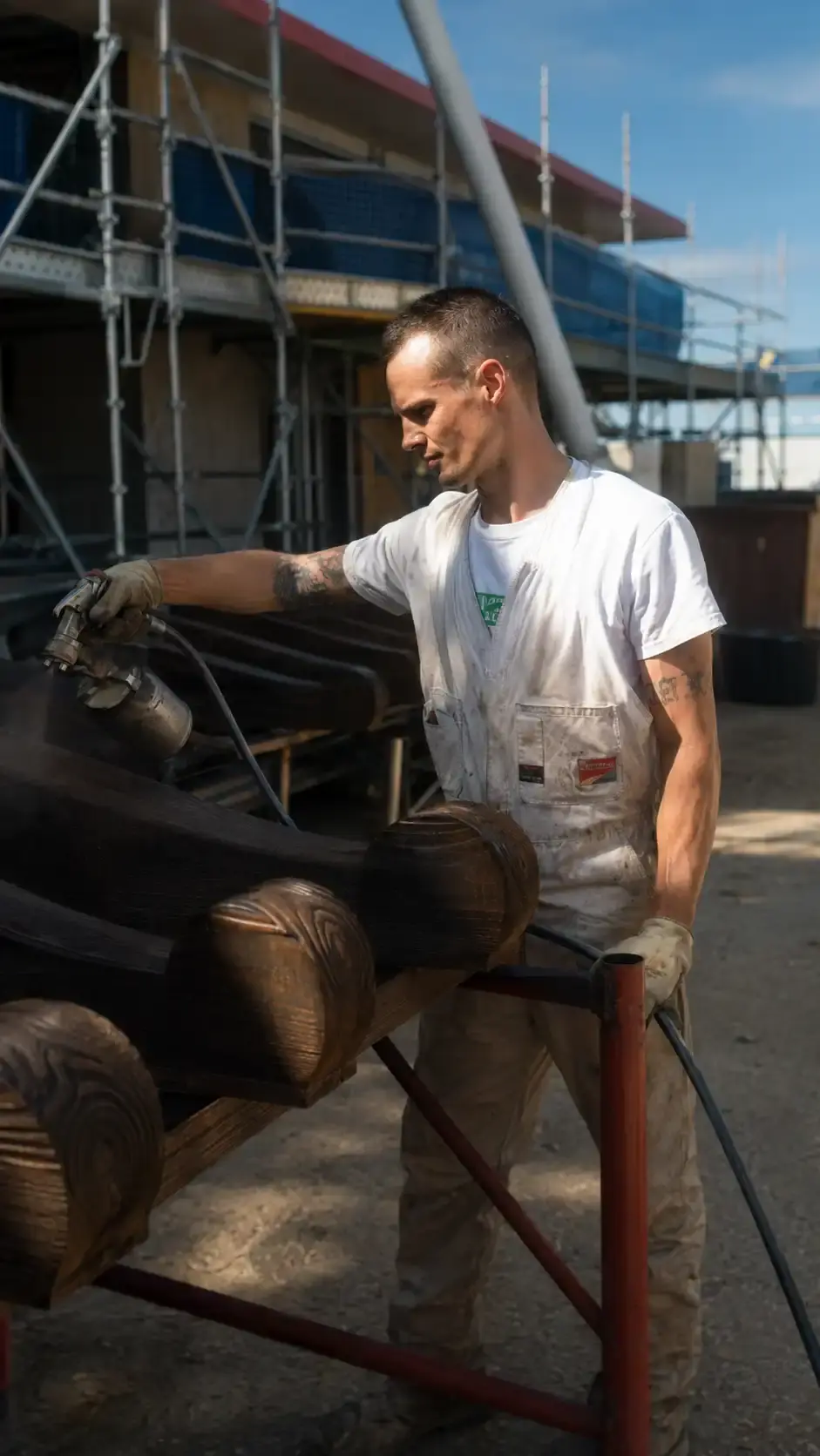 Marcel spraying imported New Zealand douglas fir rafters for Villa Vittoria